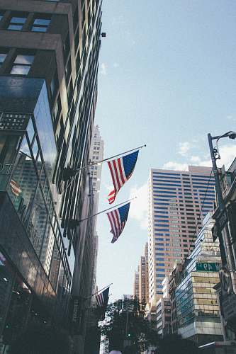building two USA flag mounted on building architecture